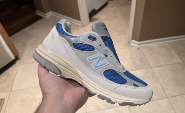 Photos Surface of a Grey and Blue Kith Friends and Family New Balance 993