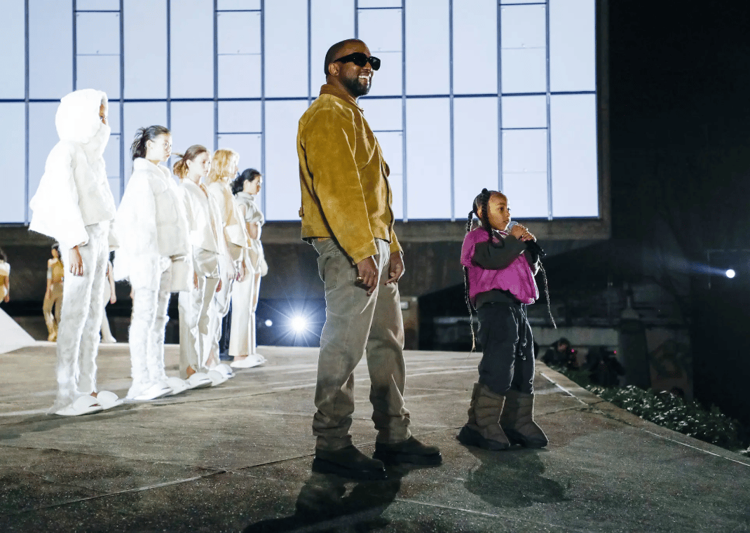 Ye and his daughter North West at the Yeezy Season 8 Runway Show in Paris, France