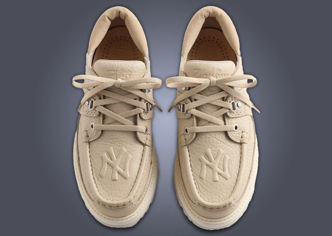 Aaron Judge, Jazz Chisholm, and the New York Yankees are gearing up for an October playoff push in the Bronx, and downtown, Ronnie Fieg and Kith are getting gear ready to support the squad. In addition to a collection of outerwear modeled by Yankees legend George Costanza - sorry, Jason Alexander - Kith is dropping a two-pack of Clarks boots with Yankee logos front and center.  The New York Yankees x Clarks 8th st by Ronnie Fieg Sunderland pack features two pairs of boots, one in navy blue and the other in light sand. The monochrome colorways feature uppers made of soft pebbled leather with supple suede on the ankle collar and a tan leather insole. The Yankees' interlocked “NY” logo is embossed proudly on the toecap of each shoe, with “Yankees” written in cursive script on the left tongue and insole, and Ronie’s “Fieg” logo imprinted on the tongue of the right shoe.   Designed by Fieg, the Sunderland is a low-top boot with a sporty hiking sole and classic Clarks raised toebox stitching. Introduced in Winter 2024, the Sunderland was featured again in the Spring 2025 collection. Now, amidst crystal-studded baseball bats and Yankees Avirex bombers, the boot is back in time for the Bronx Bombers’ postseason chase.   The New York Yankees x Clarks 8th st by Ronnie Fieg Sunderland pack will be released September 26, 2025 through Kith retail locations in-store and online. Available in men’s sizing, the retail price is set at $200. For all the info on new Kith collabs and more, make sure to download the Sole Retriever mobile app.