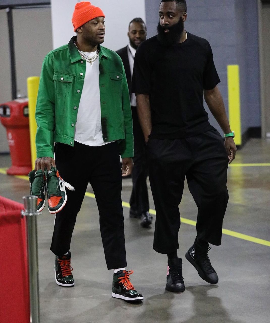 PJ Tucker walking with James Harden while wearing and holding SoleFly Jordans