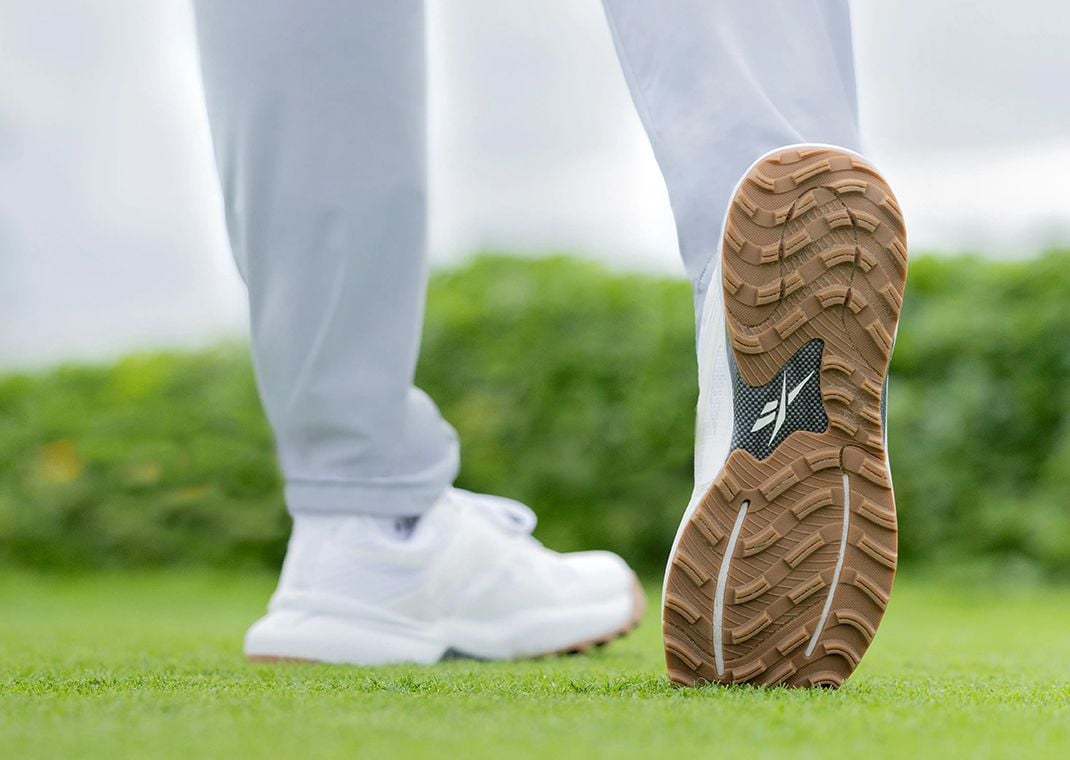 Bryson DeChambeau wearing a Reebok golf shoe