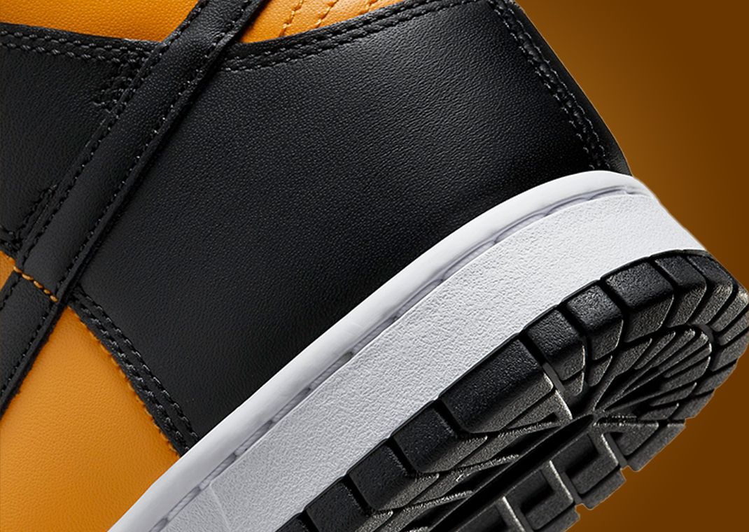 This Nike Dunk High Is Dressed In University Gold Black