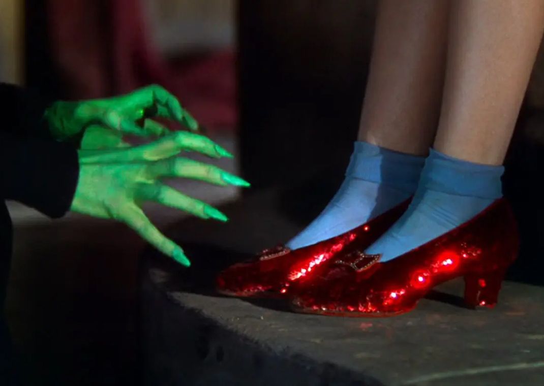 Judy Garland wearing the ruby red slippers in The Wizard of Oz