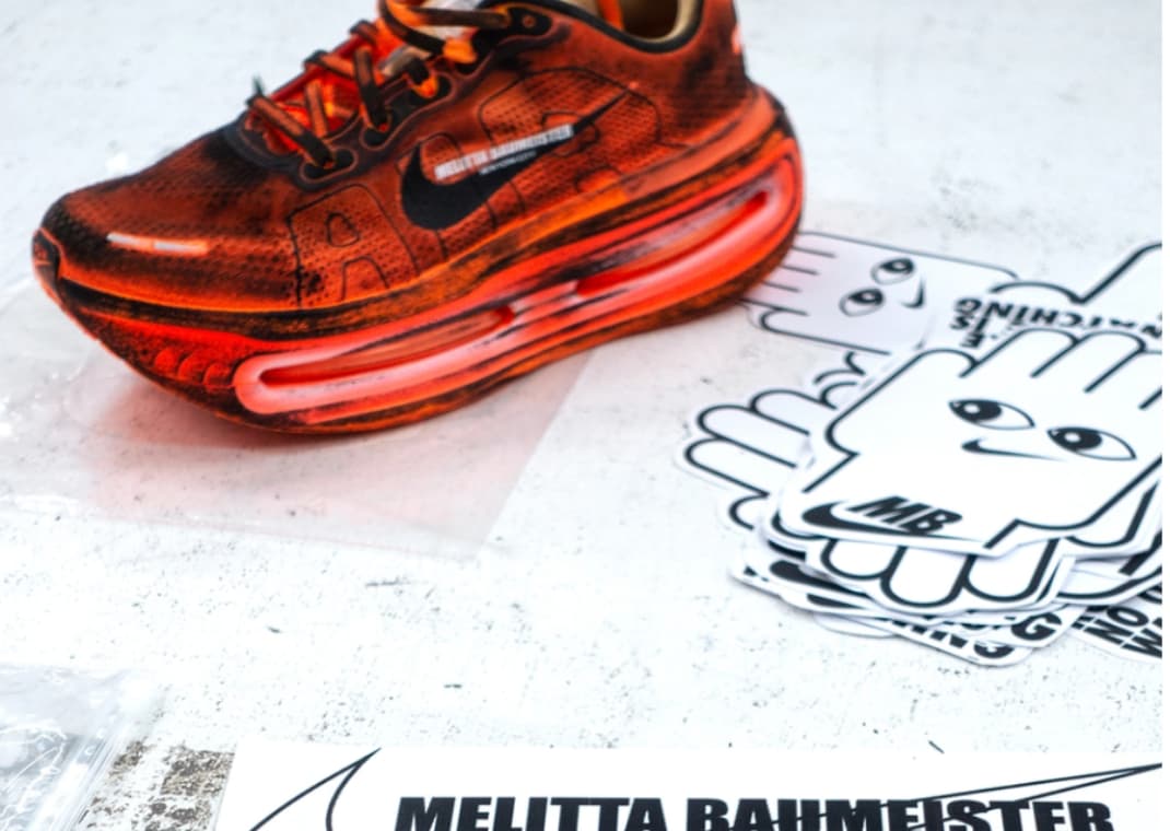 Designer Melitta Baumeister Swirls Black and Orange on Hand