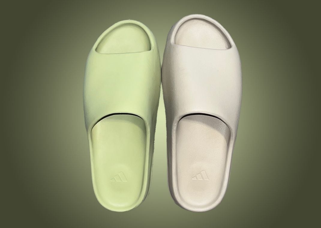 Two Size 14 adidas Yeezy Slides With The Original Release "Resin" (Left) Compared To The New Released "Pure"