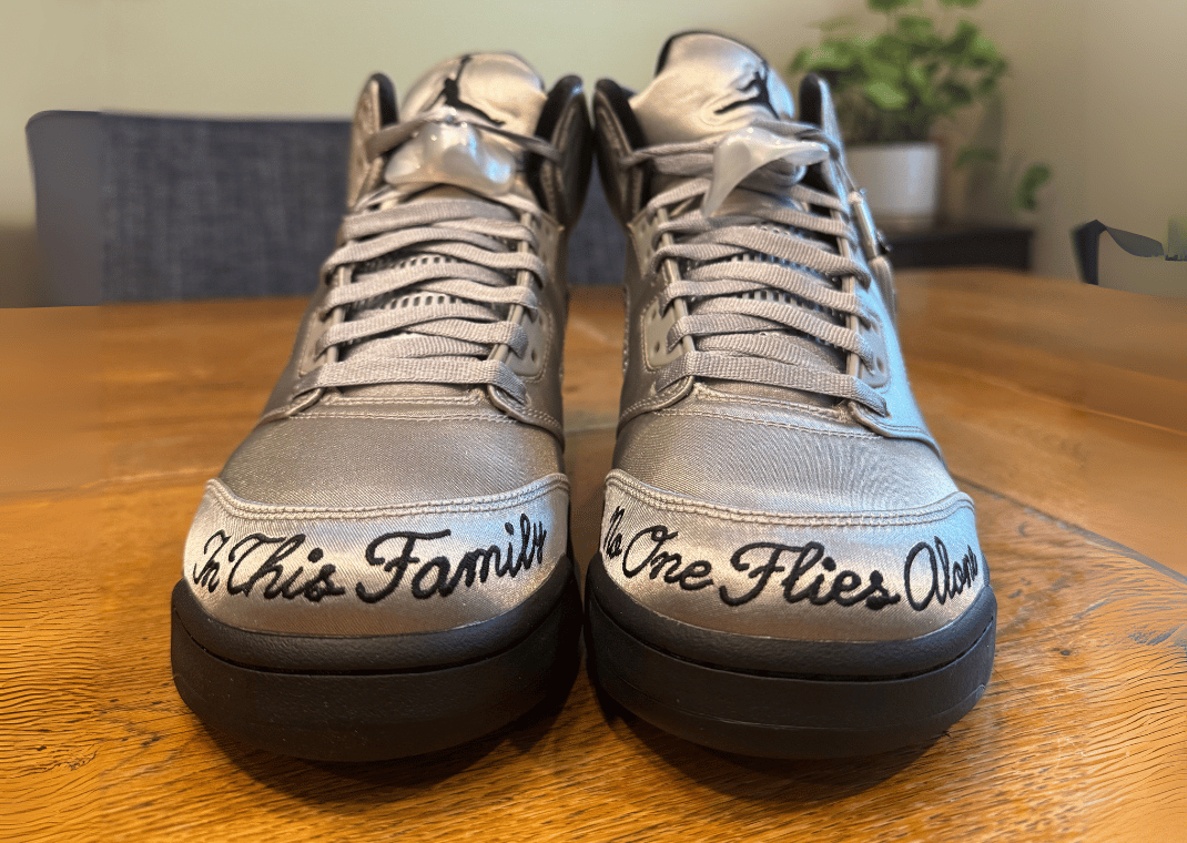 Air Jordan 5 Retro Wings toecap, featuring the phrase "In this family, no one flies alone"