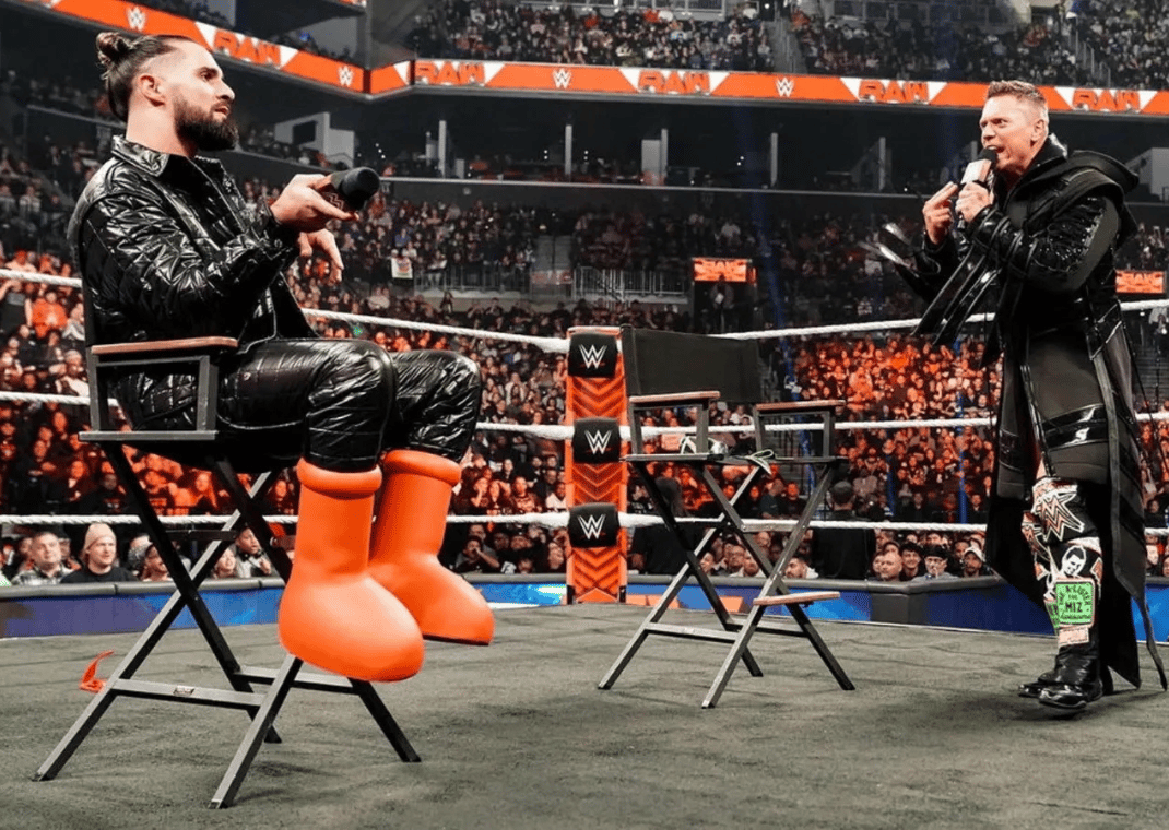 Seth Rollins cutting a promo with The Miz in the MSCHF Big Red Boot