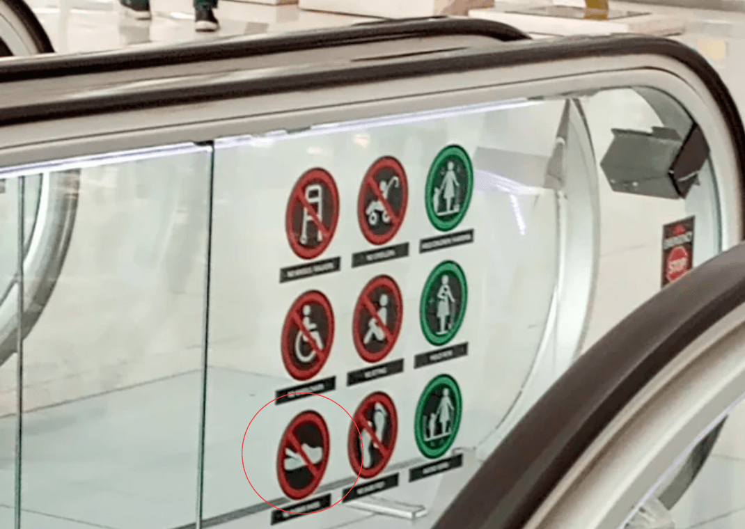 Crocs Prohibited Sign On Escalator (Image via