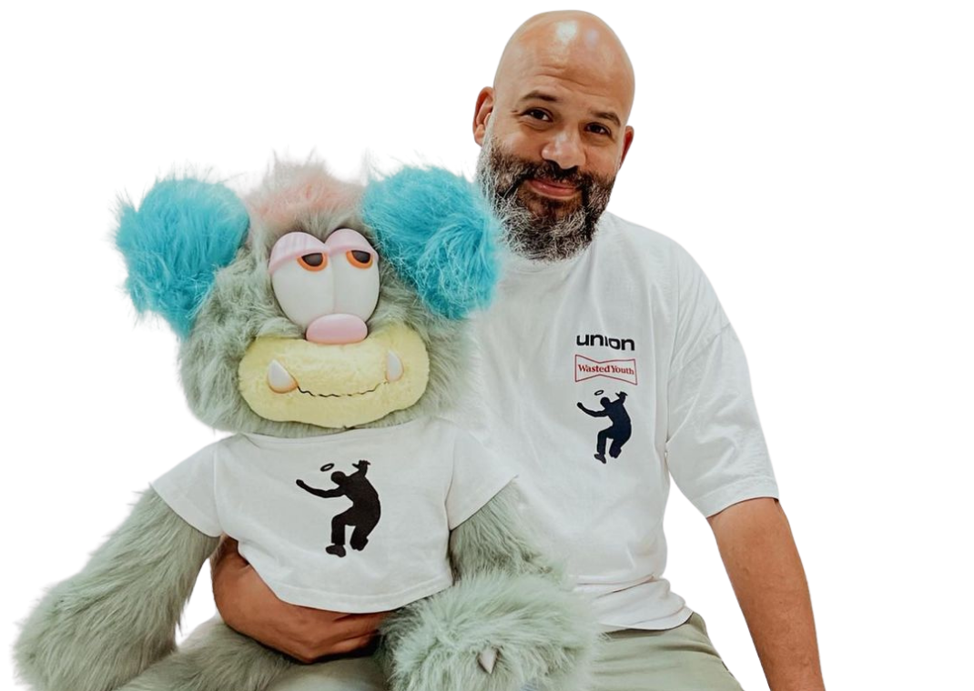 Chris Gibbs posing with 3 VISTY Plush