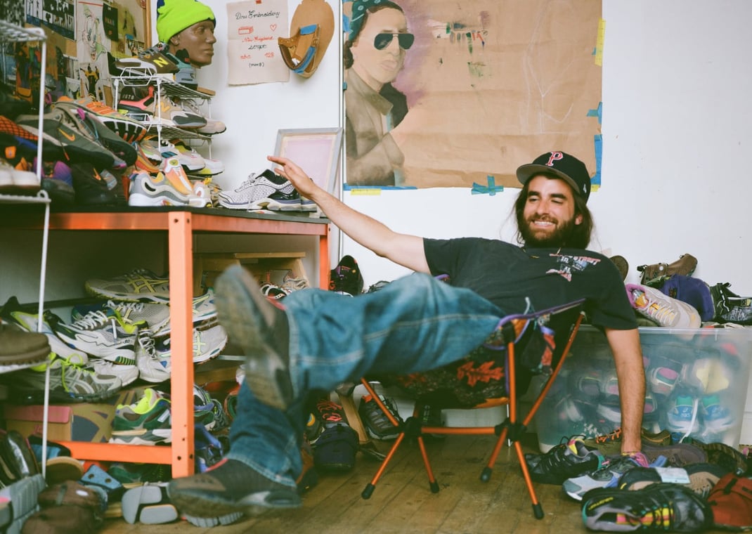 Drew White with shoes he's designed