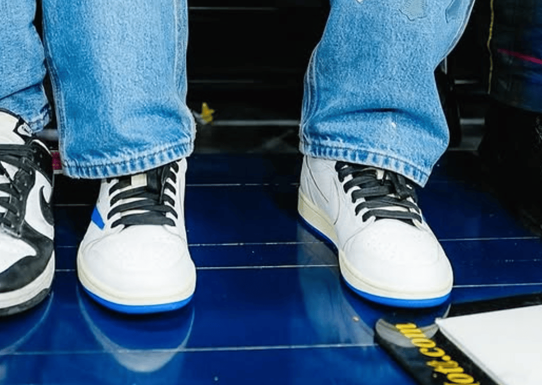 Travis Scott wearing the upcoming Travis Scott x fragment design x Air Jordan 1 Retro Low OG Sail Military Blue