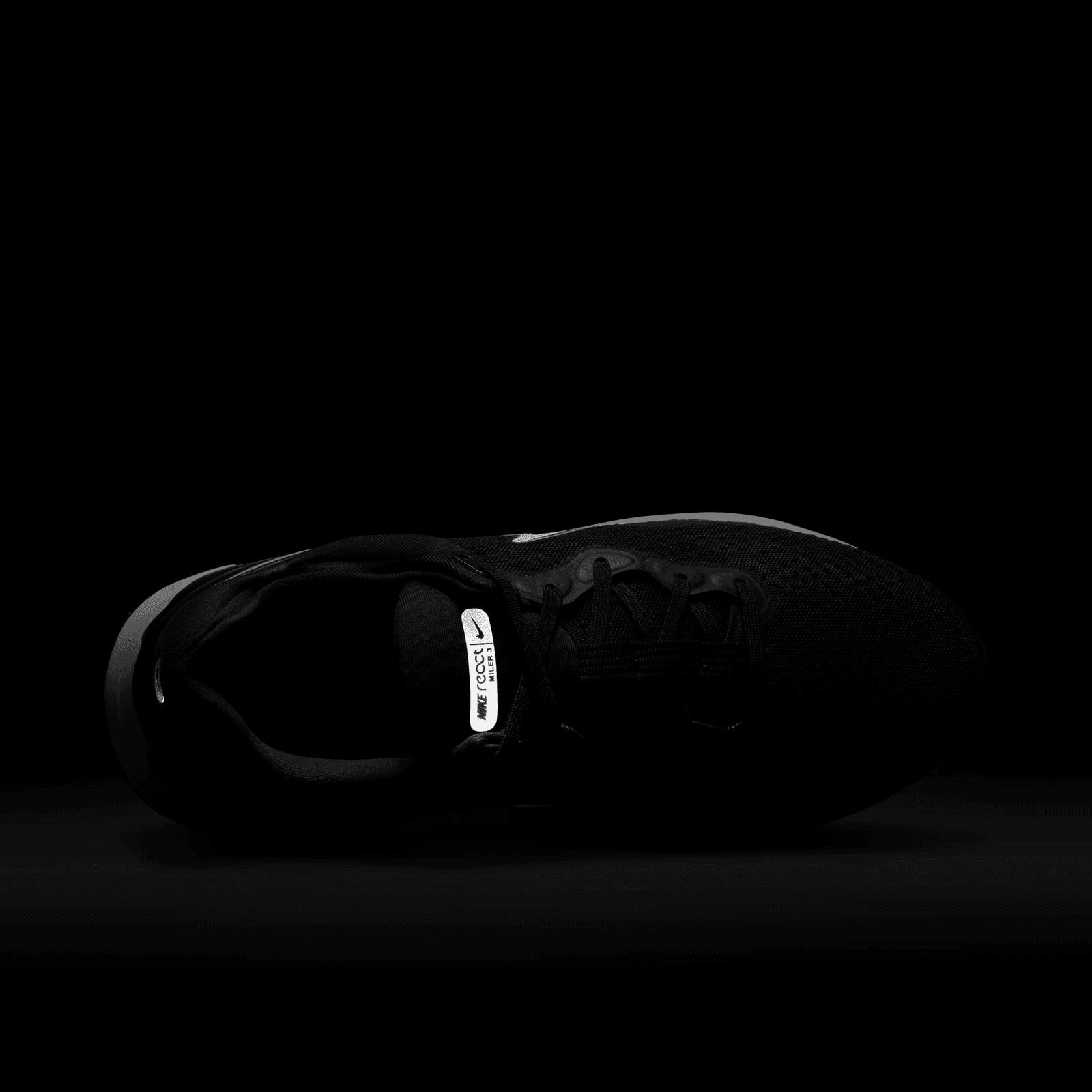 nike running react miler trainers in triple black